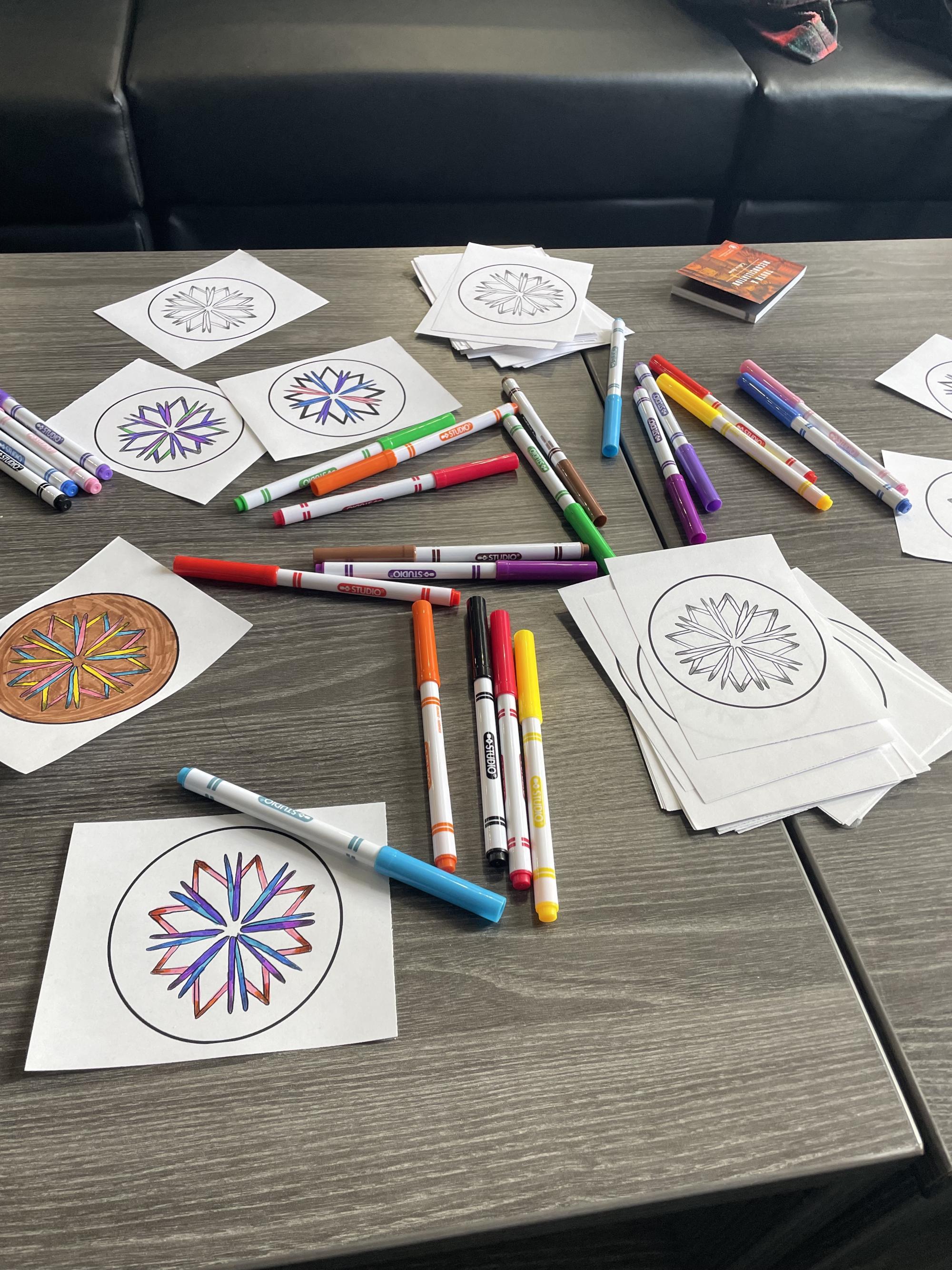 [ID: "Colouring pages of porcupine quill medallions depicting the Mi'kmaw 8-point star."]