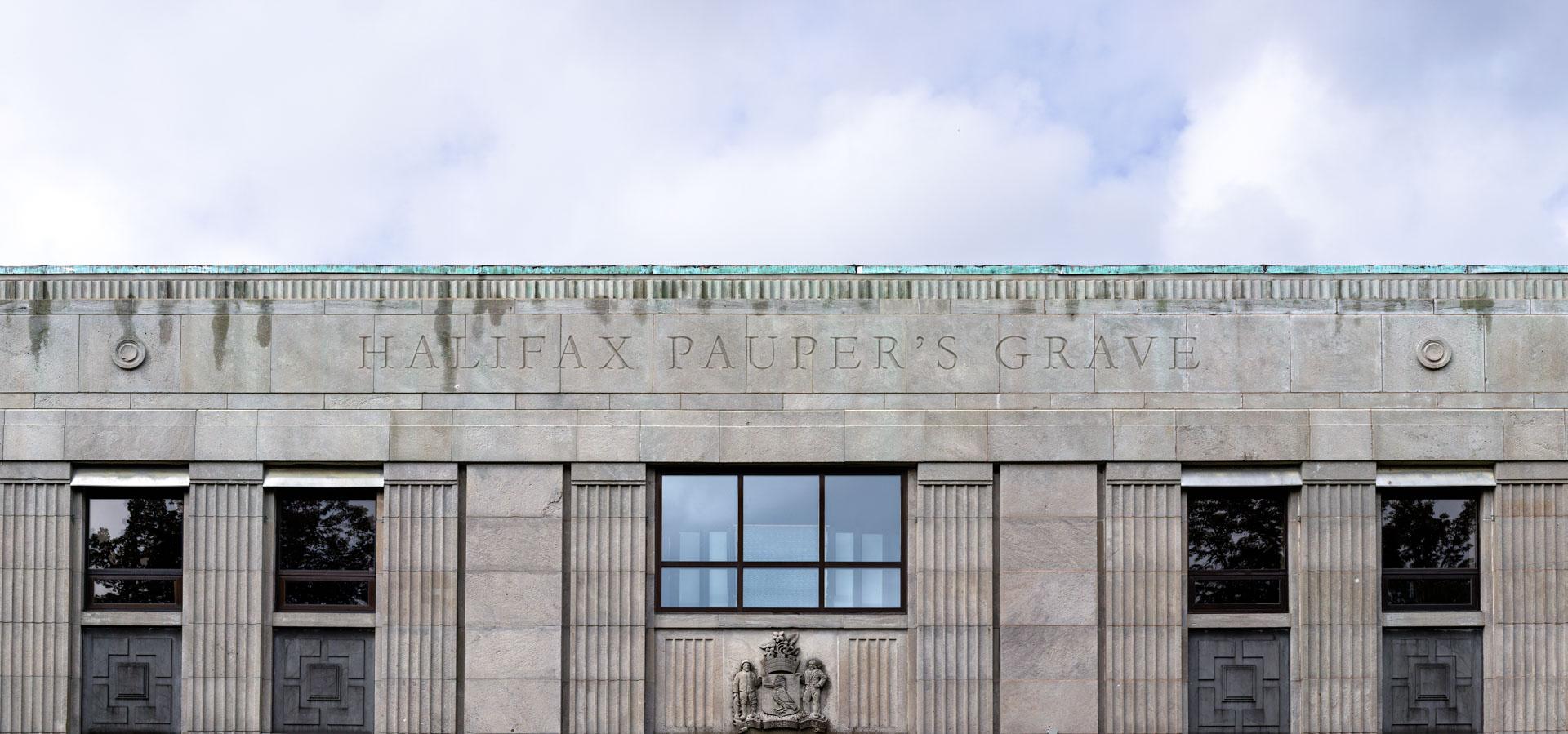 Photo of the top of the Halifax Memorial Library reading "Halifax Pauper's Grave"