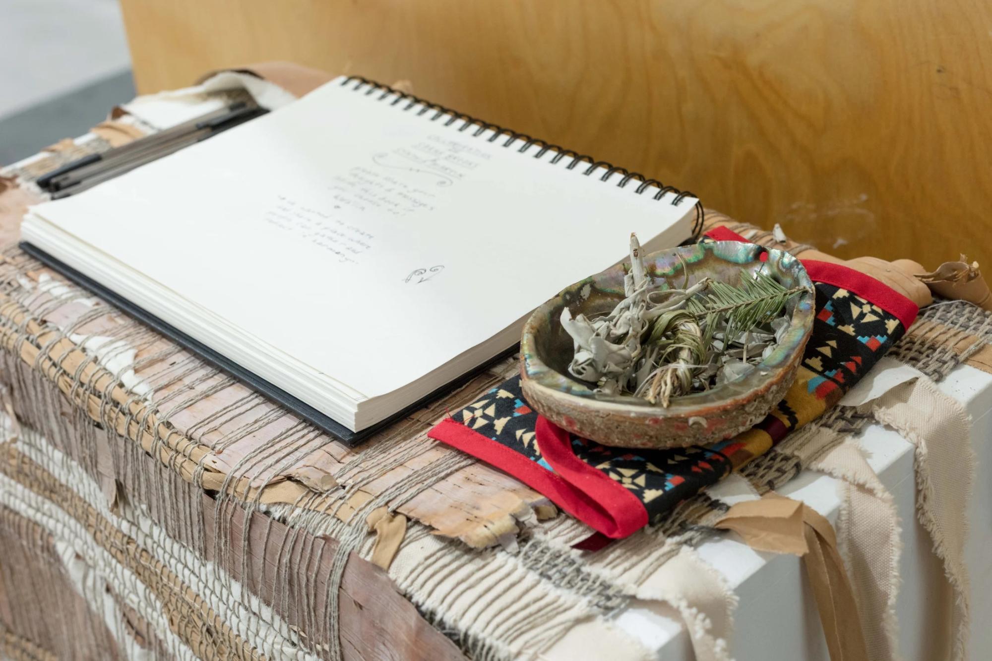 closeup of guest book and smudge bowl