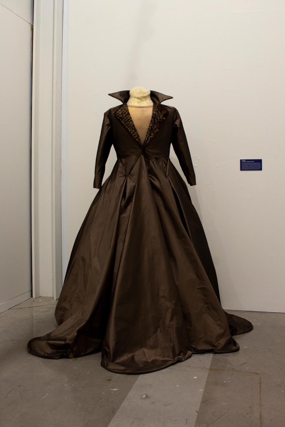 long brown dress mounted on a form