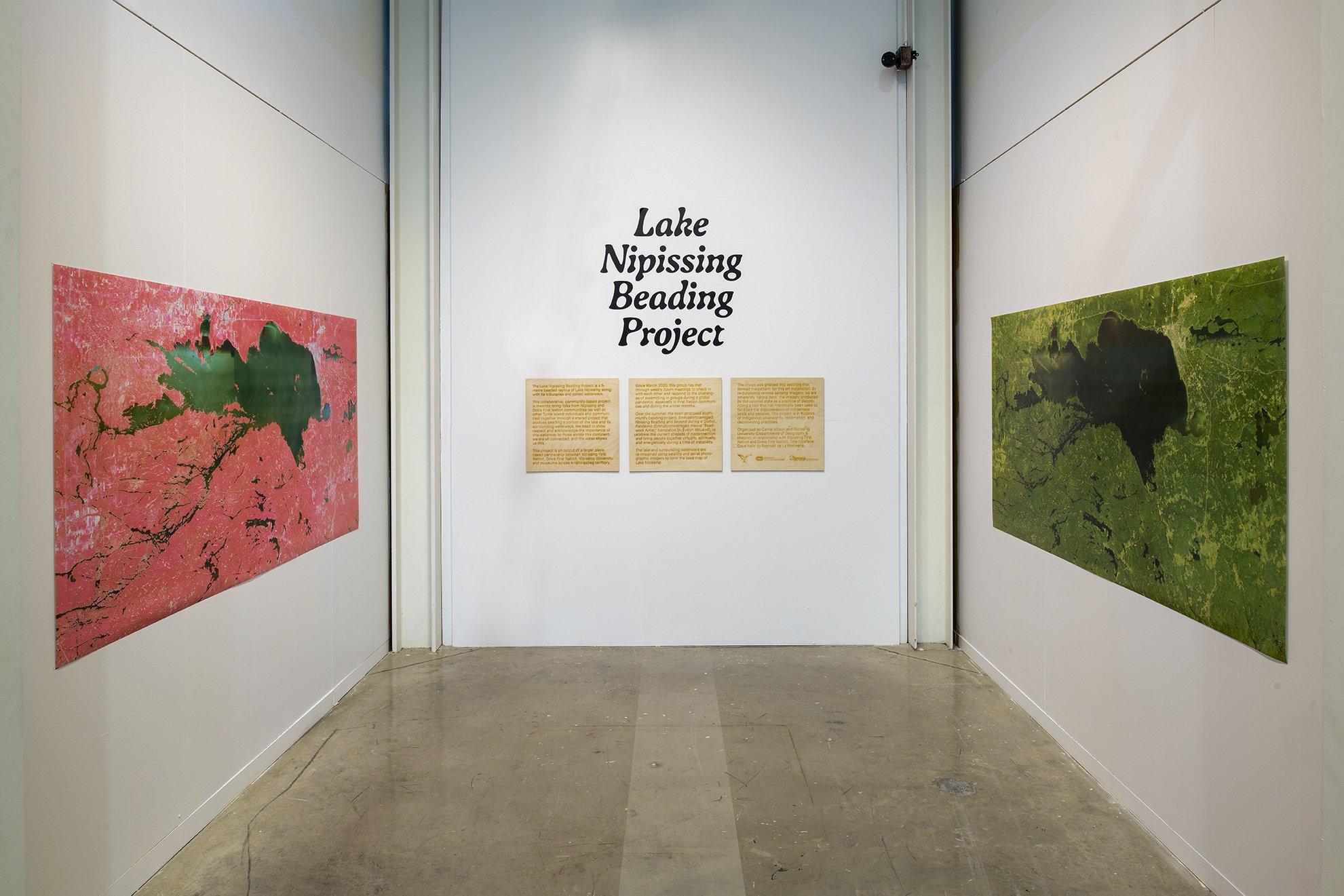 photo of exhibition title wall framed by two gis map prints of Lake Nipissing