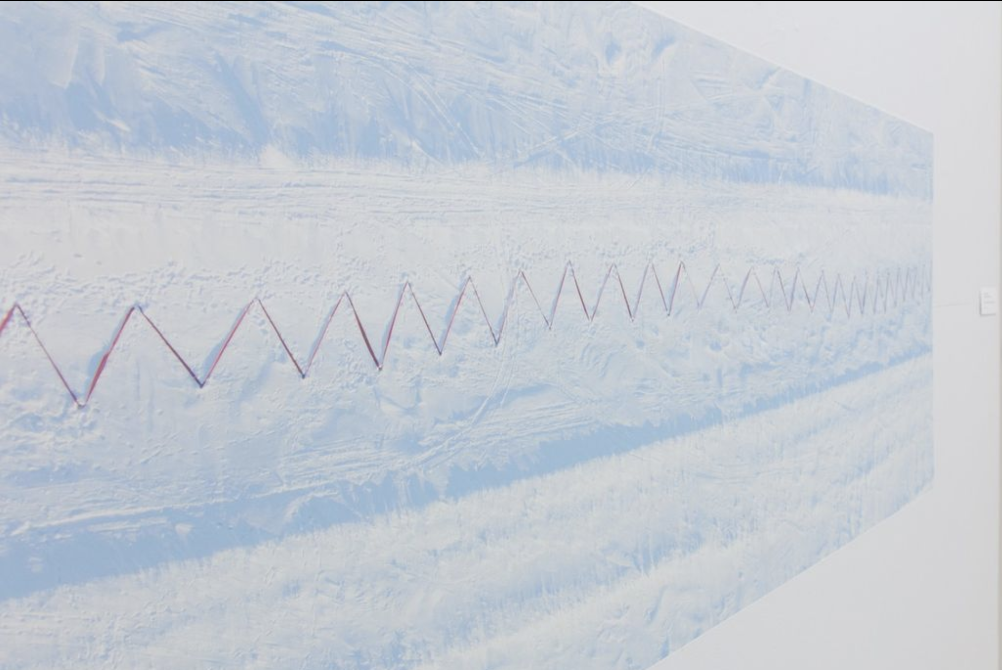 closeup of Maureen's print of her work with a white snowy background landscape with red zig zag across it