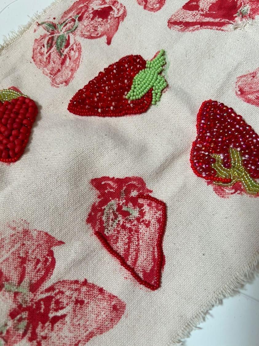 Beaded red strawberries on canvas