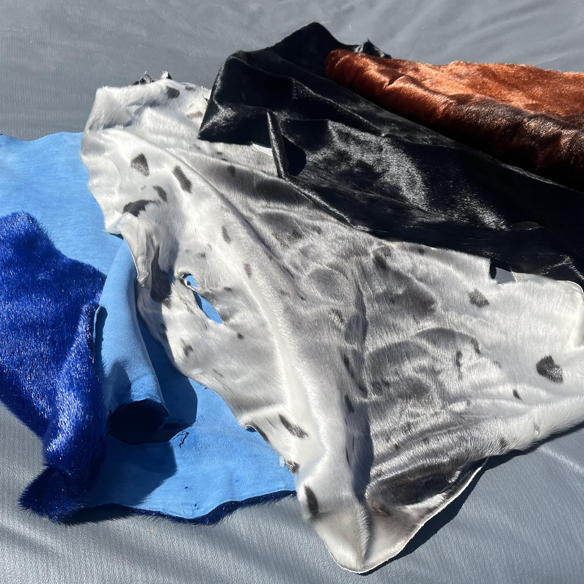 Blue, black, and orange dyed sealskin laid with natural silver sealskin.