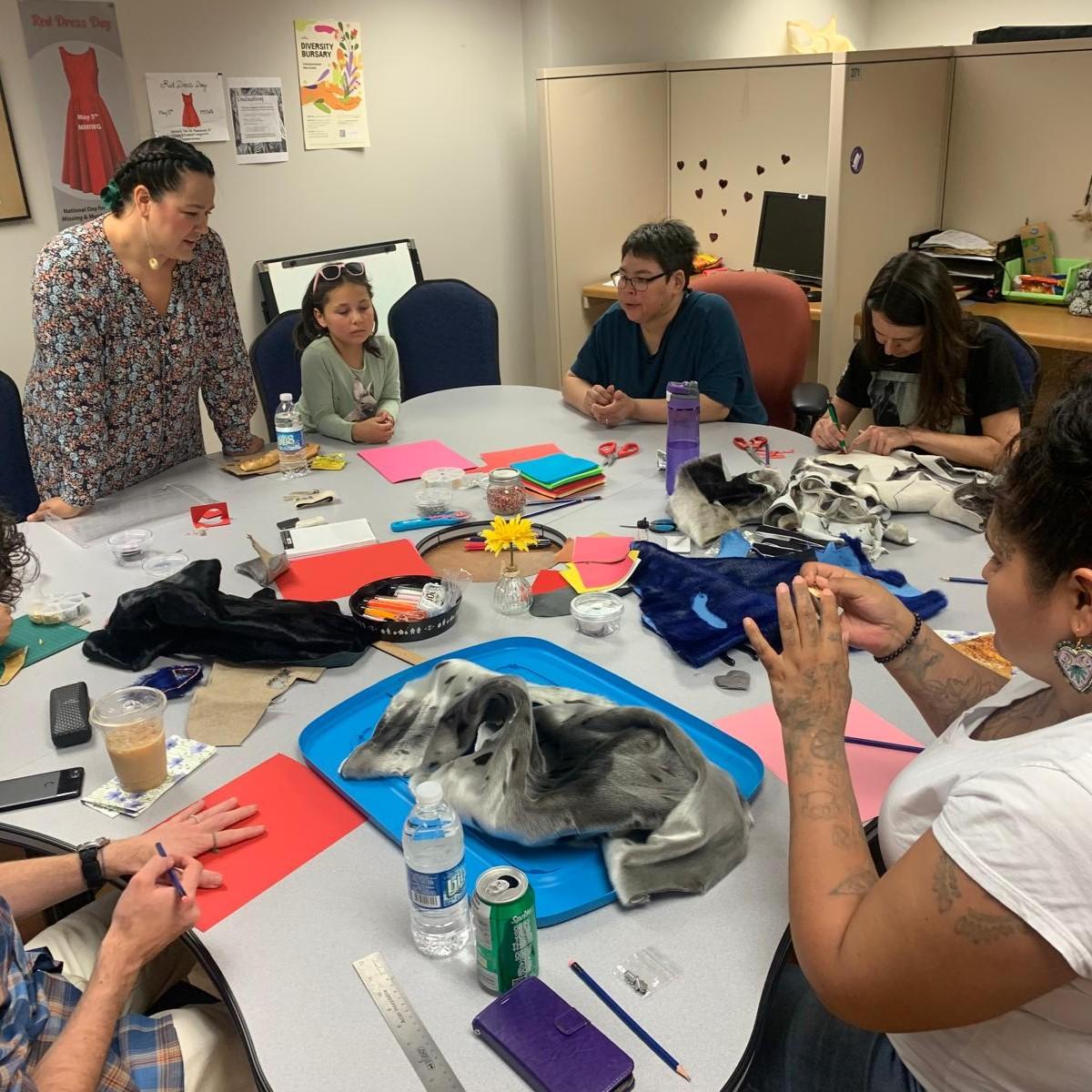 table filled with Sealskin and crafting materials surrounded by Participants