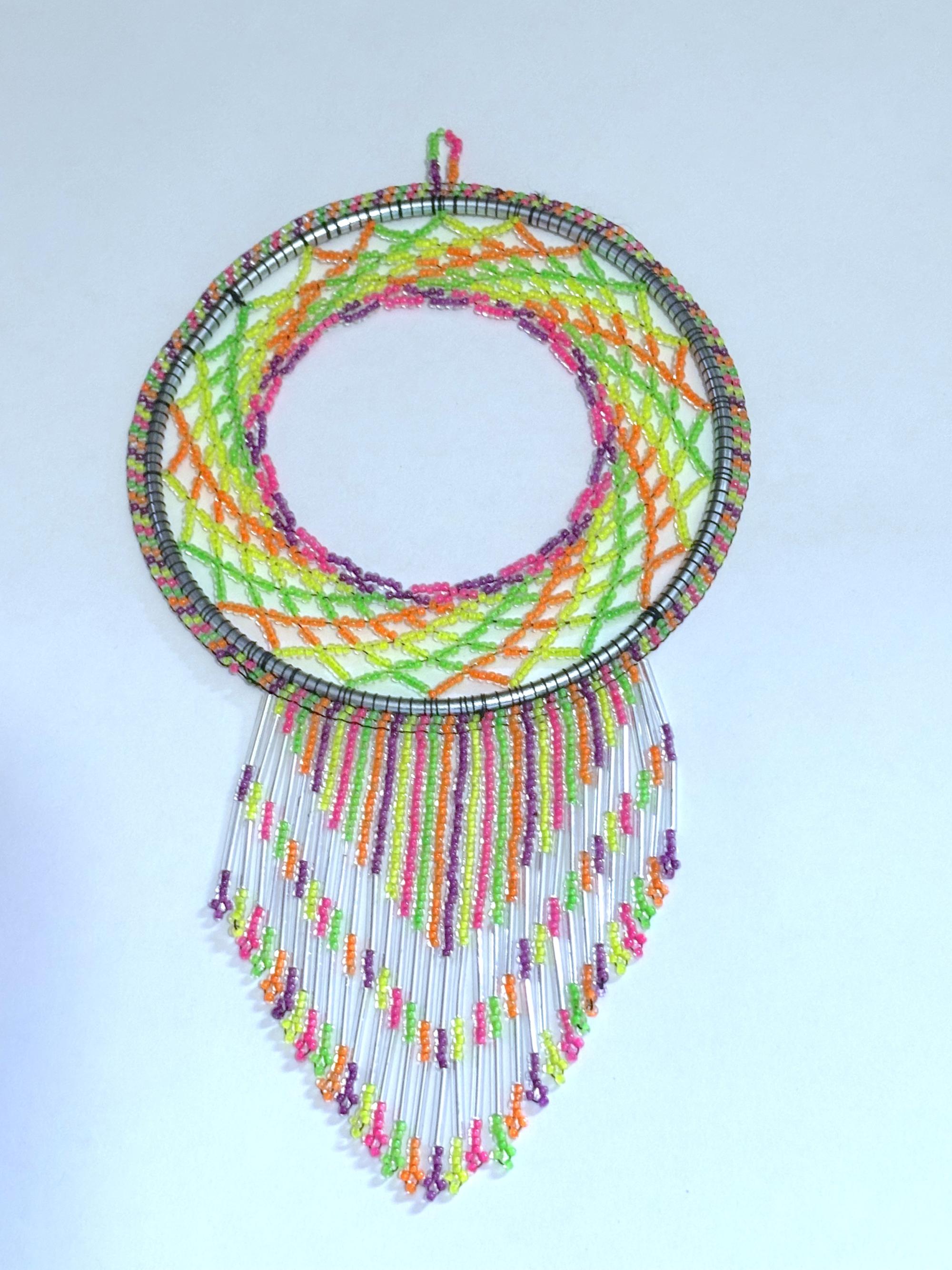 photograph of a beaded dreamcatcher in pink, yellow, green, orange and purple glass seed beads
