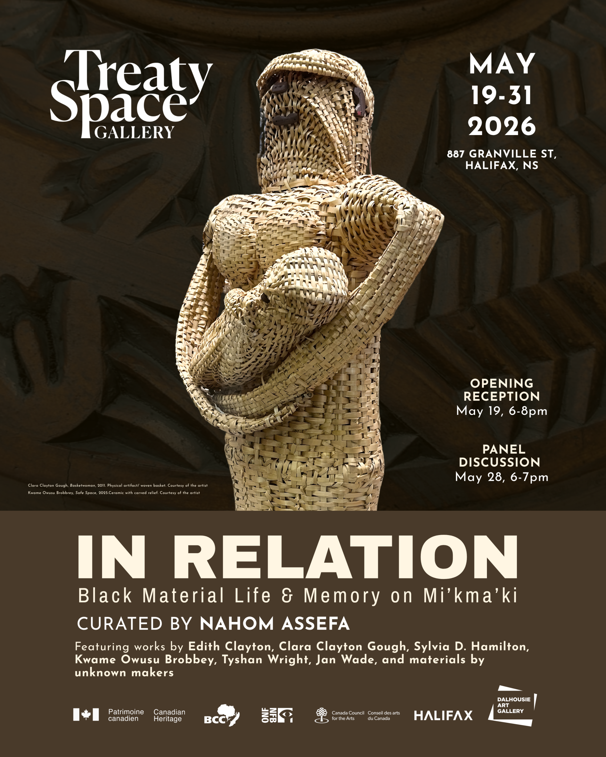 Basket woven sculpture in the form of a woman holding a baby.