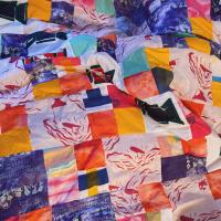 A photo of a colourful patchwork quilt.