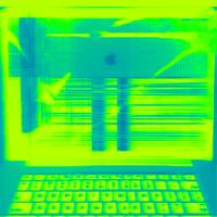 A spectrogram image of a smashed Mac laptop with keyboard and smashed screen. Image is predominantly fluorescent light green and medium dark teal.