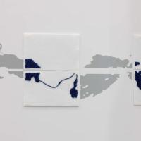 beaded squares on a white wall made up of small glass blue beads in the outline of the river