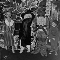 Four children dressed in Halloween costumes in the 70's
