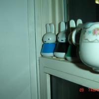Photograph-themed markers and teacup next to window    