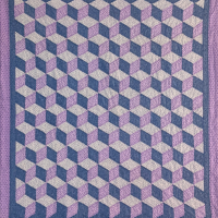 The photo features a close-up of a purple and white checkered cloth. The fabric showcases a distinct pattern, highlighting its lilac hues and textile qualities. It is reminiscent of traditional quilt designs, emphasizing the craftsmanship involved in stitching and needlework.